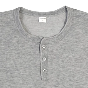 Close-up of Henley neckline with three buttons on light gray cotton knit fabric shirt