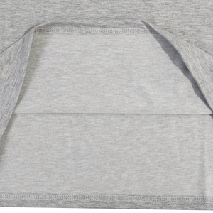 Detailed macro view showing the double-needle stitching on grey cotton t-shirt hem