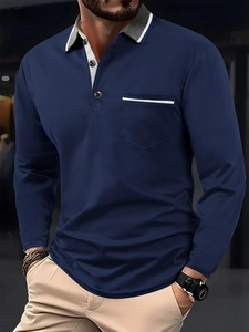 Detail of navy long-sleeve polo shirt with grey tipped collar and striped chest pocket