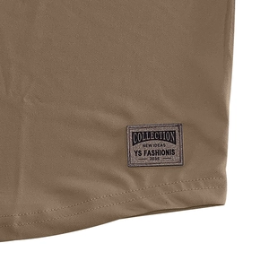Detail view of tan Henley shirt hem featuring high-quality stitching and woven logo label