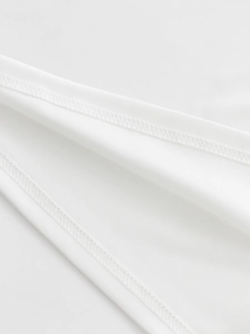 Macro view of high-quality double-stitch sewing and texture on a white quick-dry polo shirt