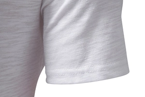 Detail of white cotton shirt sleeve showing breathable slub texture and double stitching