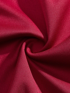 Close-up of deep red honeycomb mesh fabric for men's long sleeve polo shirts