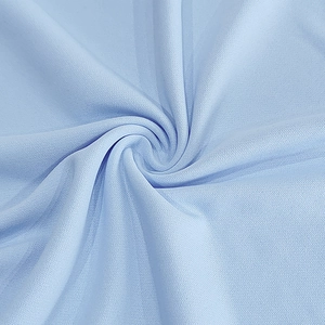 Detailed macro view of light blue breathable knitted mesh fabric showing texture and elasticity