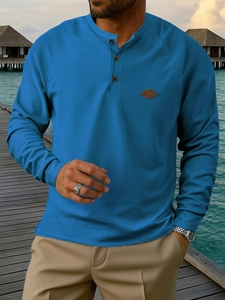 Men's navy blue waffle knit Henley shirt with long sleeves and buttoned neckline