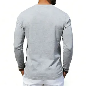 Rear view of a men's long sleeve grey heather t-shirt with a comfortable loose fit style