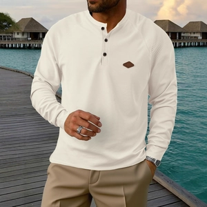 Detail view of waffle knit fabric and leather patch on men's ivory henley shirt