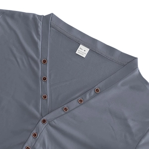 Close-up of V-neck buttons and fabric care label for men's Henley shirt