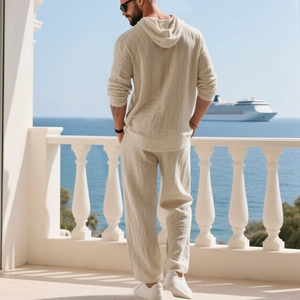 Rear view of men's beige linen hooded shirt and drawstring trousers on a sunlit terrace