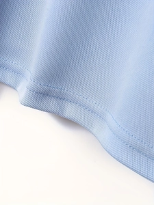 Light blue knit mesh polo shirt hem detail with professional double stitching finish