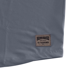 Detailed macro shot of double-needle hem stitching and vintage brown leather brand label