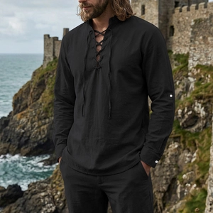 Close-up of the vintage lace-up V-neck detail on a black linen medieval style men's shirt