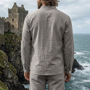 Rear view of vintage grey linen shirt and trousers set at a scenic coastal cliff
