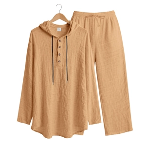 Detailed close-up of yellow linen-texture men's henley shirt with buttons and drawstring
