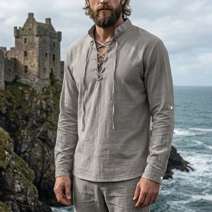 Detailed view of grey linen lace-up shirt collar with textured fabric in outdoor scenery