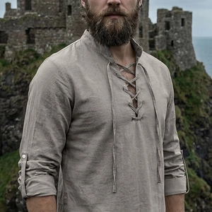 Detail of medieval linen shirt with lace-up collar and adjustable button sleeves
