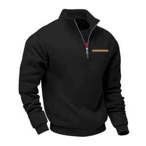 Detail of half-zip stand collar with metallic zipper and brown leather trim on black sweatshirt