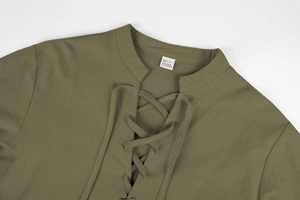 Detail of olive green linen shirt showing V-neck lace-up design and size L fabric label