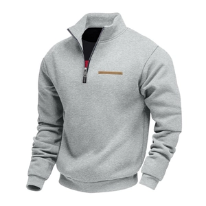 Detail of grey men's sweatshirt showing stand collar, half-zip and leather chest strip