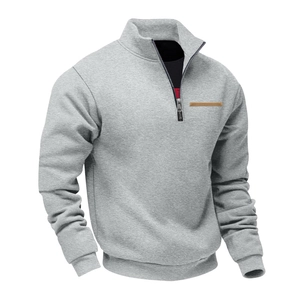 Detail of grey half-zip sweatshirt with stand collar and brown contrast patch