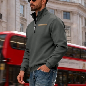 Detail showing high-collar dark grey quarter-zip fleece sweatshirt with brown chest strip