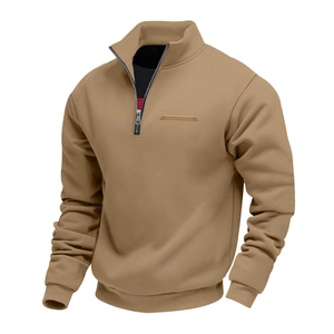 Detail of the 1/4 zipper stand collar and ribbed cuffs on khaki fleece sweatshirt