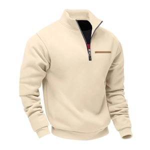 Detail of ribbed cuffs and brown chest strip on men's beige fleece quarter-zip sweater