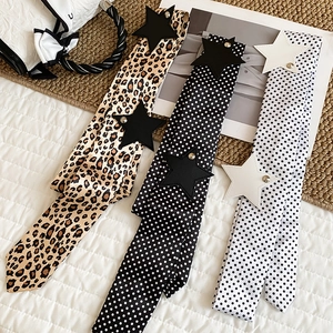 Detailed view of Y2K style silk belts with polka dot, leopard prints and star studs.
