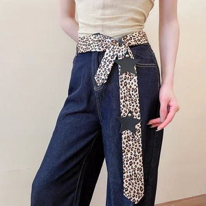 Close-up of Y2K leopard print belt with black star leather accents