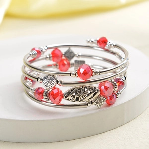 Detailed view of red faceted crystal multi-layer wrap bracelet with silver charms