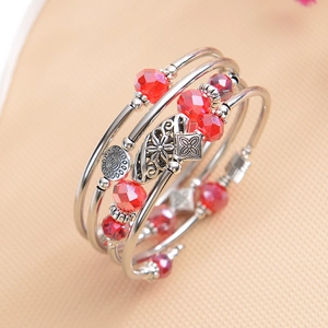 Detail view of a stylish red faceted crystal multi-layer wrap bracelet for women's summer wear