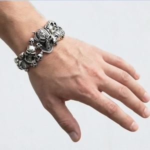 Detailed view of carved skull elements on vintage punk stainless steel bracelet for men