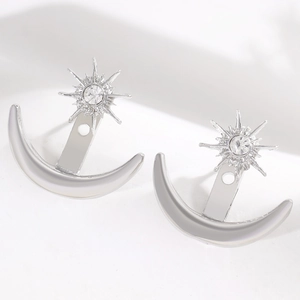 Detailed view of silver star and moon stud earrings featuring sparkling rhinestones