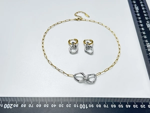 Minimalist two-tone interlocking ring necklace and earrings set with measurement scale.