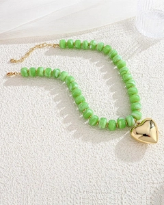 Green marbled resin bead necklace with a large polished gold heart pendant