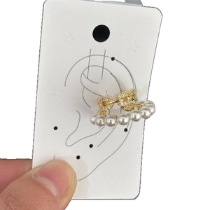 Elegant gold C-shaped ear cuff jewelry with white pearls and sparkling pave zircon stones