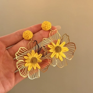 Elegant large yellow flower statement earrings with intricate woven details and golden wire