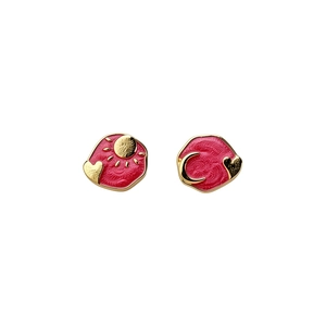 Elegant asymmetrical red enamel heart stud earrings featuring gold sun and moon designs