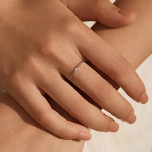 Minimalist S925 sterling silver moissanite ring worn on a model's finger for stacking