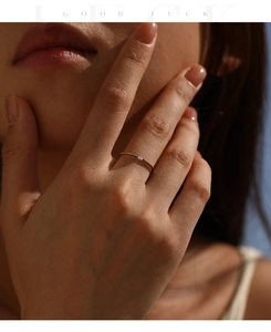 Close-up of minimalist S925 sterling silver stacking ring with small stone on hand