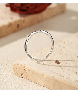 Detailed side view of a minimalist S925 sterling silver moissanite stacking ring.