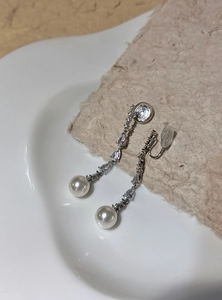 Elegant long dangle clip-on earrings featuring white pearls and shimmering cubic zirconia.