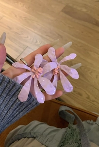 Oversized lavender flower stud earrings with pink stamen detail shown for size reference