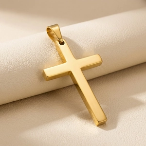 Detailed macro shot of a polished gold minimalist cross pendant on a textured background