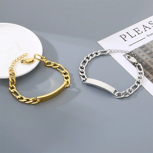 Detail of minimalist gold and silver titanium steel NK chain bracelets with polished bars.