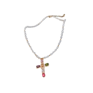 Elegant white pearl necklace featuring a colorful zircon cross pendant on white background