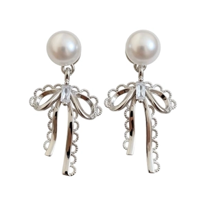 Elegant French style bow stud earrings with white pearl and sparkling crystal detail.