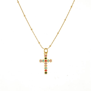 Detail of gold plated stainless steel necklace with colorful crystal cross pendant