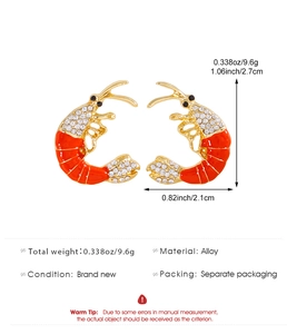 Detail view of red enamel lobster earrings with dimensions 2.7cm by 2.1cm and weight 9.6g