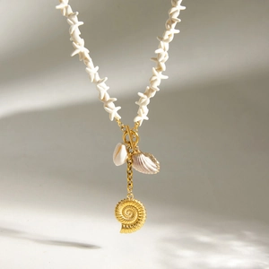 Close-up of ocean-themed stainless steel necklace with starfish beads and golden shell